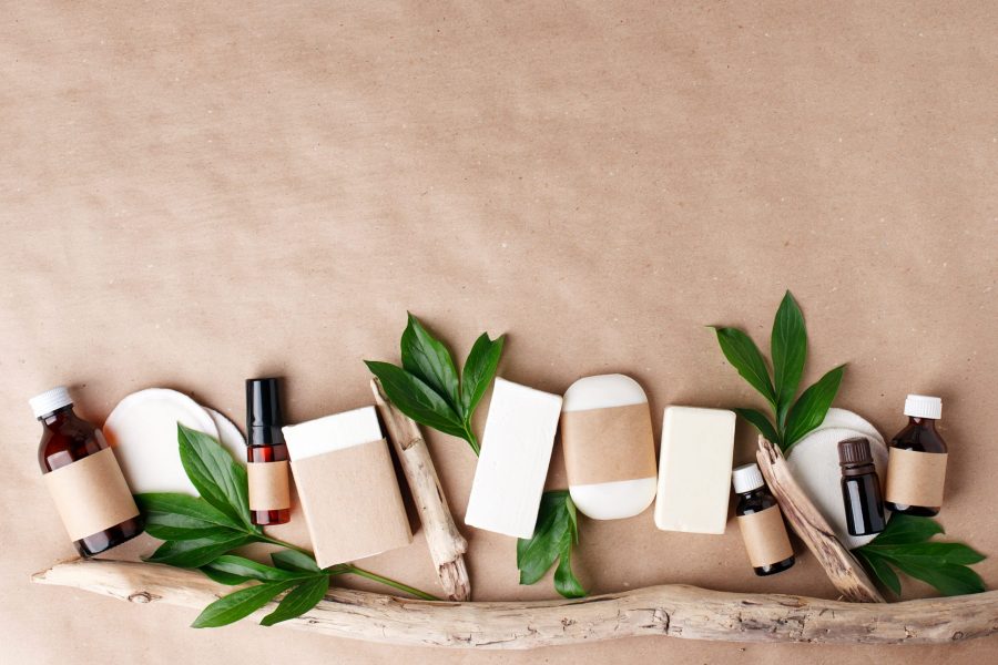 Zero waste natural cosmetics products on craft paper table. Flat lay, organic solid soap and shampoo bars, antibacterial handcrafted soap concept, mock up, organic detail, leaves